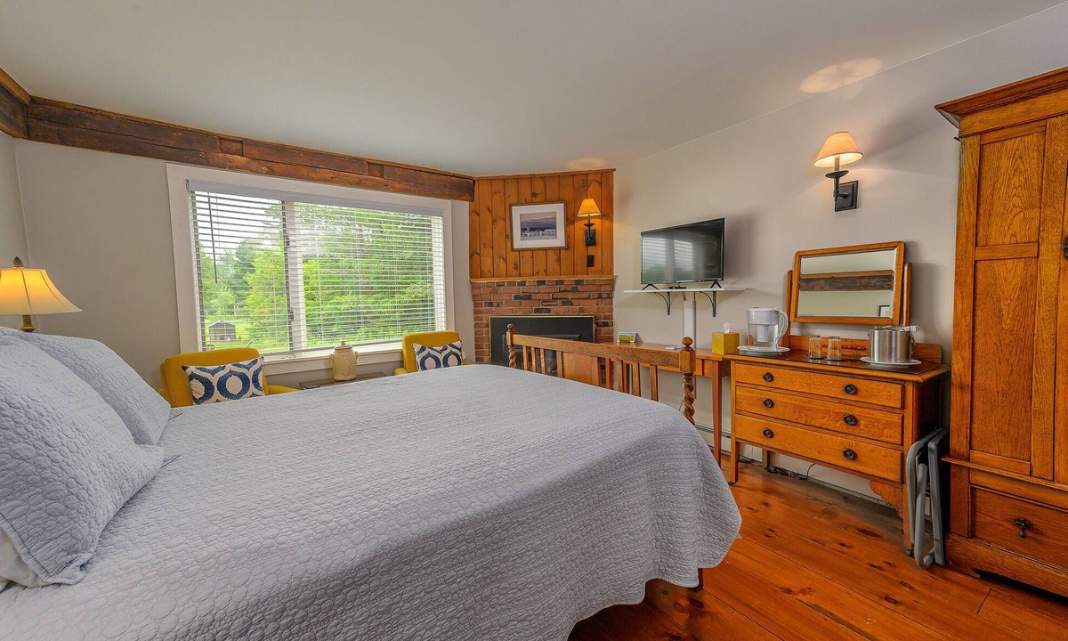 Stowe Bed & Breakfast | Comfortable, pet friendly room with queen bed, a stunning view of Mount Mansfield, sitting area and a fireplace with full service breakfast included