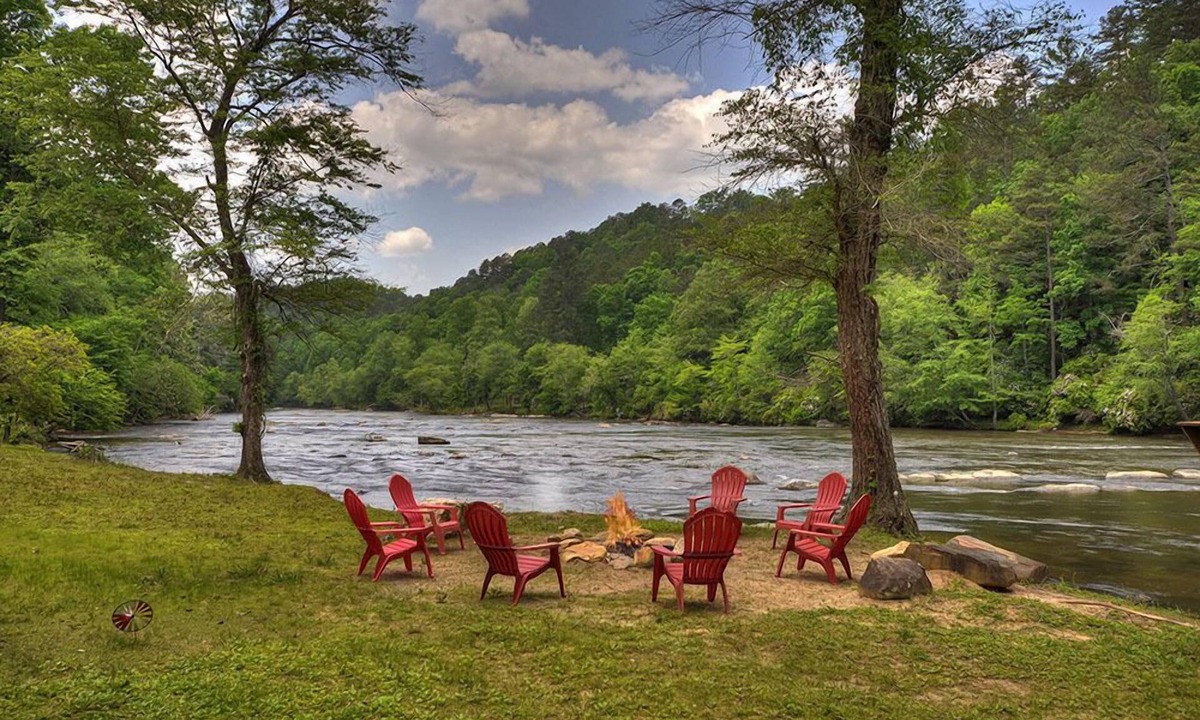 Ellijay Cabin | Hunter's Lodge, a pet-friendly riverfront cabin, complete with a pool table, lit basketball court, fire pit, dock, and WiFi
