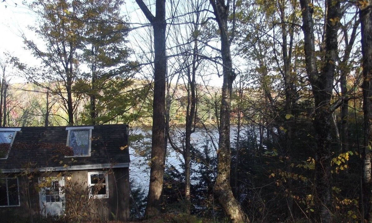 Grantham Cottage | Waterfront Camp looking down on water from deck.