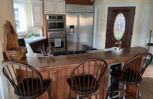 Cannon Beach House | Amazing estuary and ocean views! Relax on the deck with the fire-pit & jacuzzi