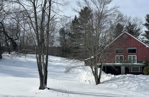 Williamstown House | Charming barn ski house with exposed rustic beams and cathedral ceilings.