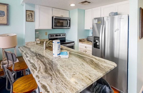 Fort Morgan Condo | Colorful, lofty condo with balcony, beach access, pools, hot tubs & tennis