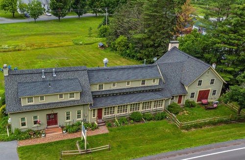 Stowe Bed & Breakfast | Comfortable room with queen bed and twin trundle, a stunning view of Mount Mansfield, sitting area with couch and a parlor stove with full service breakfast included