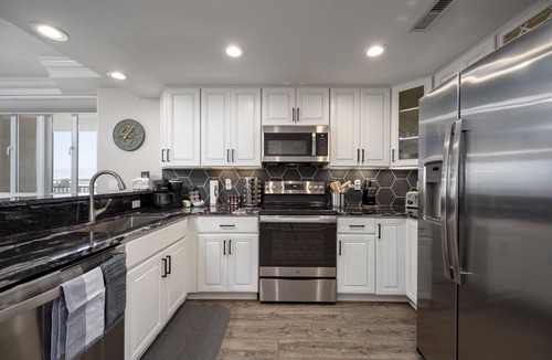 Ocean City Condo | Enjoy a large, spacious designer unit with all the extras plus an indoor pool, outdoor pool, fitness room, assigned parking and shops on the ground level.