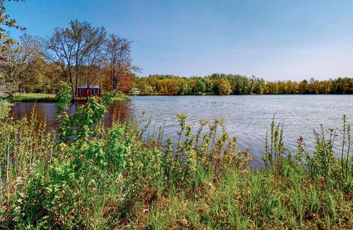 Barnstead House | Inviting riverfront home with pool, kayaks, firepit, & W/D