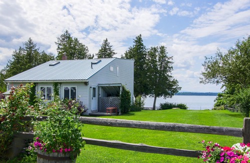 South Hero House | Lakefront Home with Patio Over the Lake, Private Dock, & Stunning Sunset Views