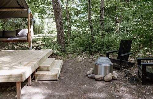 North Woodstock RV Rental | Safari Tent Site 12 | 1 King Bed | Woods View