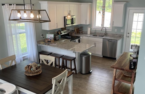 Arundel Cottage | Sunkissed cottage, resort amenities, heated pools, club house, close to beaches