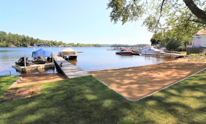 Lochmere Condo | Right on the Water at Lake Winnisquam, w/Balcony, Boat Dock, & Sandy Beach